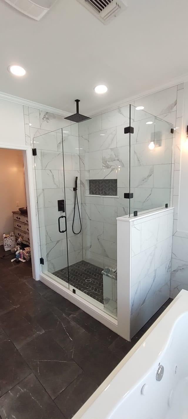 Frameless glass shower with marble tile