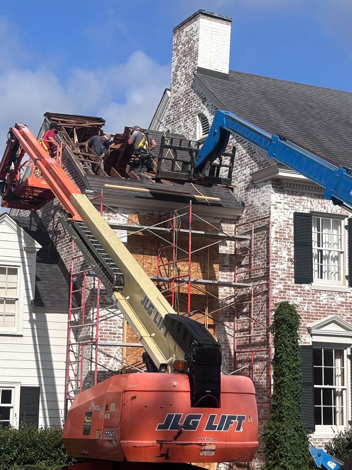 Lift and scaffolding on a brick chimney rebuild