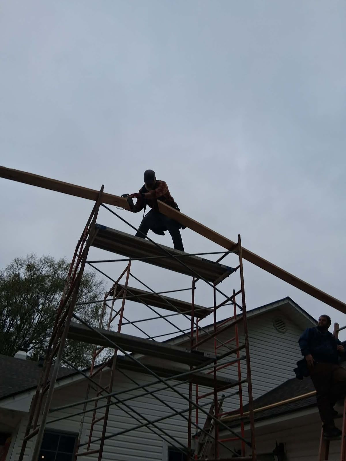 Setting a ridge beam from the scaffold