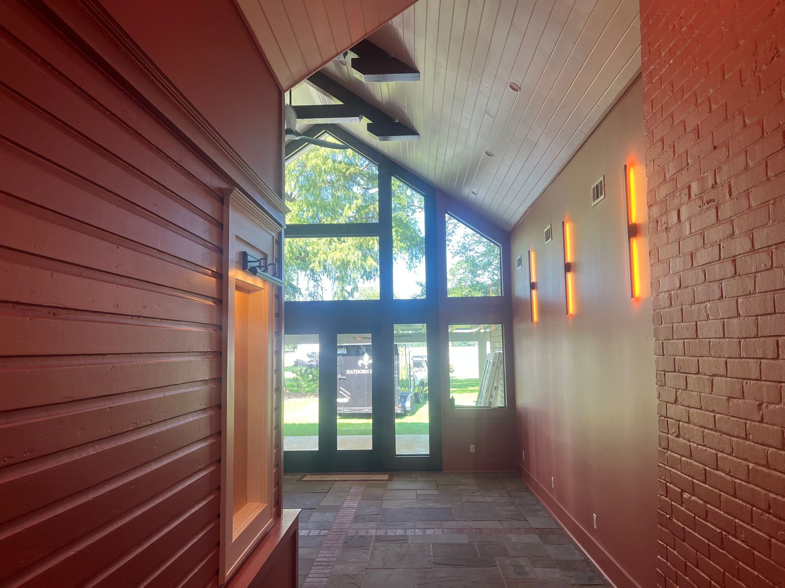 Red board walls and a glass gable entry