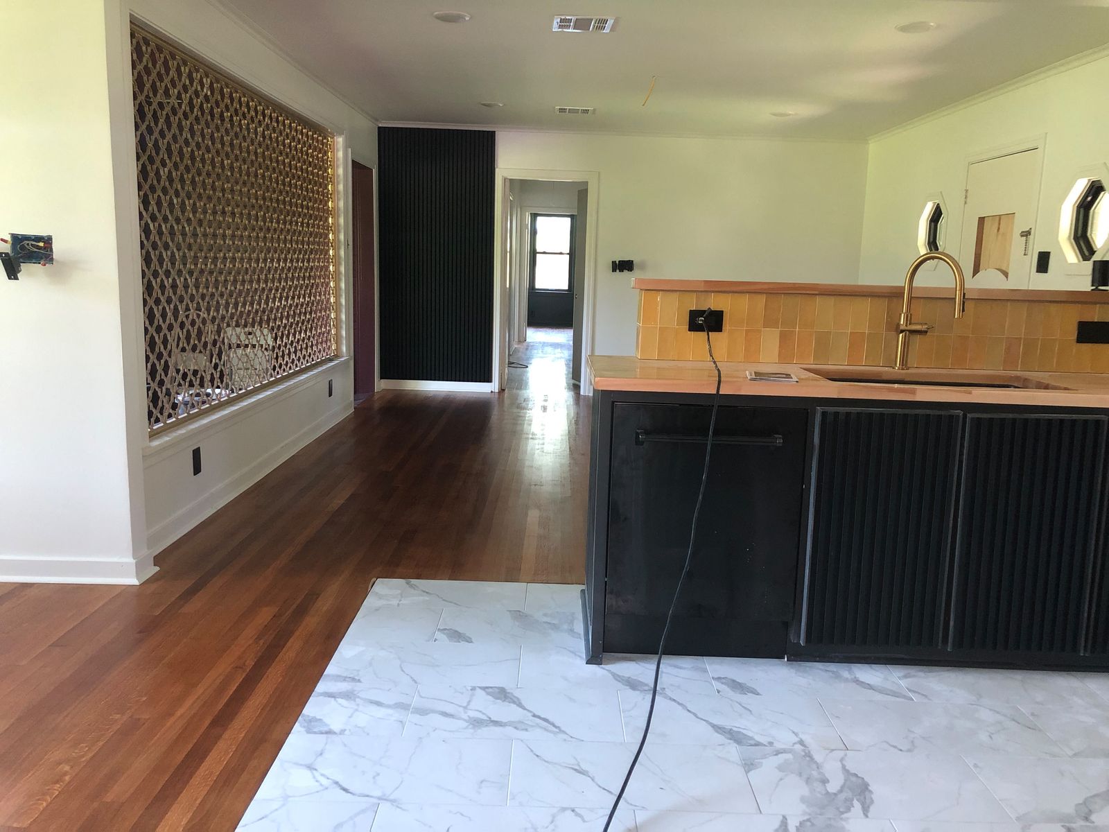 Open kitchen with marble floor and island