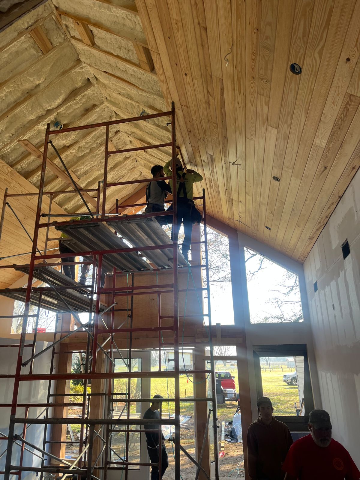Installing a pine ceiling from the scaffold